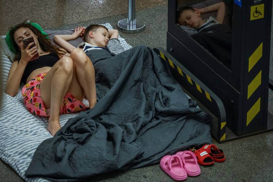 People take shelter inside a metro station during an air raid alert in Kyiv