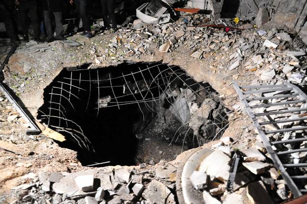 A view shows damage at the site of a rocket attack, in central Damascus's Kafr Sousa neighbourhood