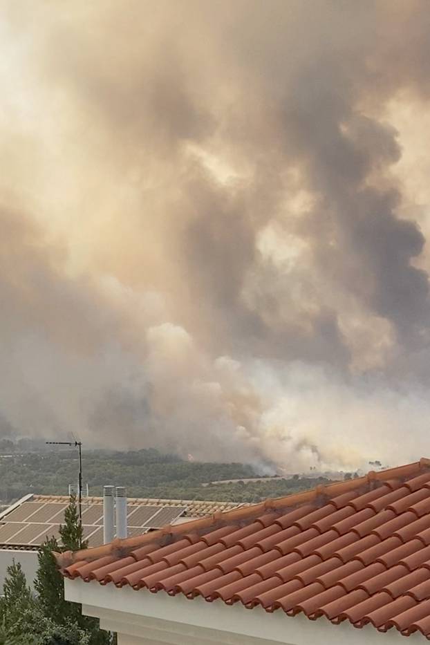 A fire blazes in Varympompi, near Athens