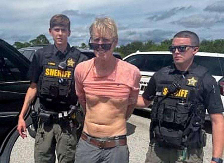 FILE PHOTO: Suspected Trump golf course gunman Ryan W. Routh stands handcuffed after his arrest during a traffic stop near Palm City