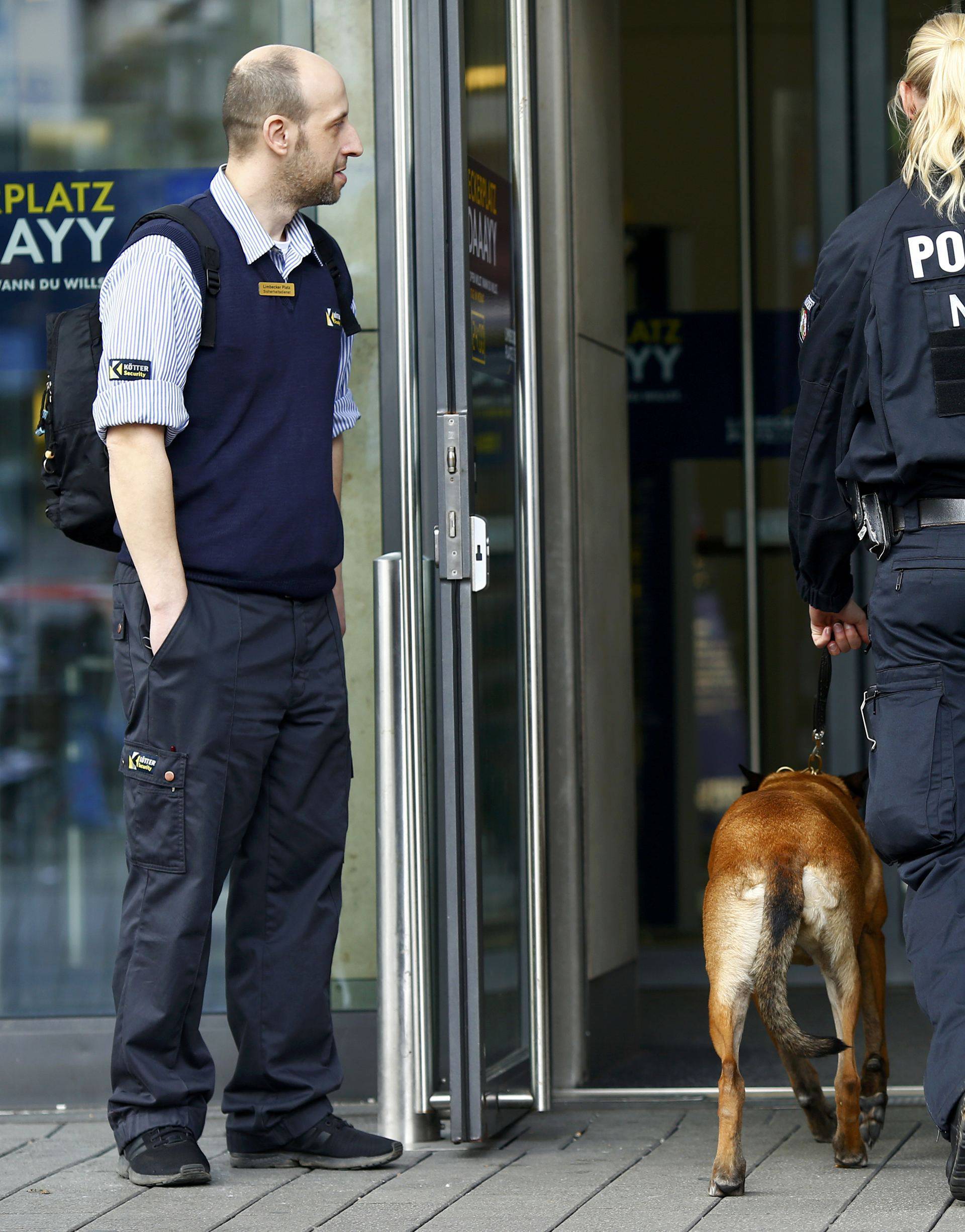 Police with a dog at the entrance of Limbecker Platz shopping mall in Essen