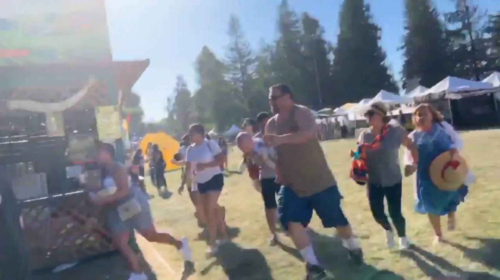 Social media video grab of people running away as an active shooter was reported at the Gilroy Garlic Festival, south of San Jose, California