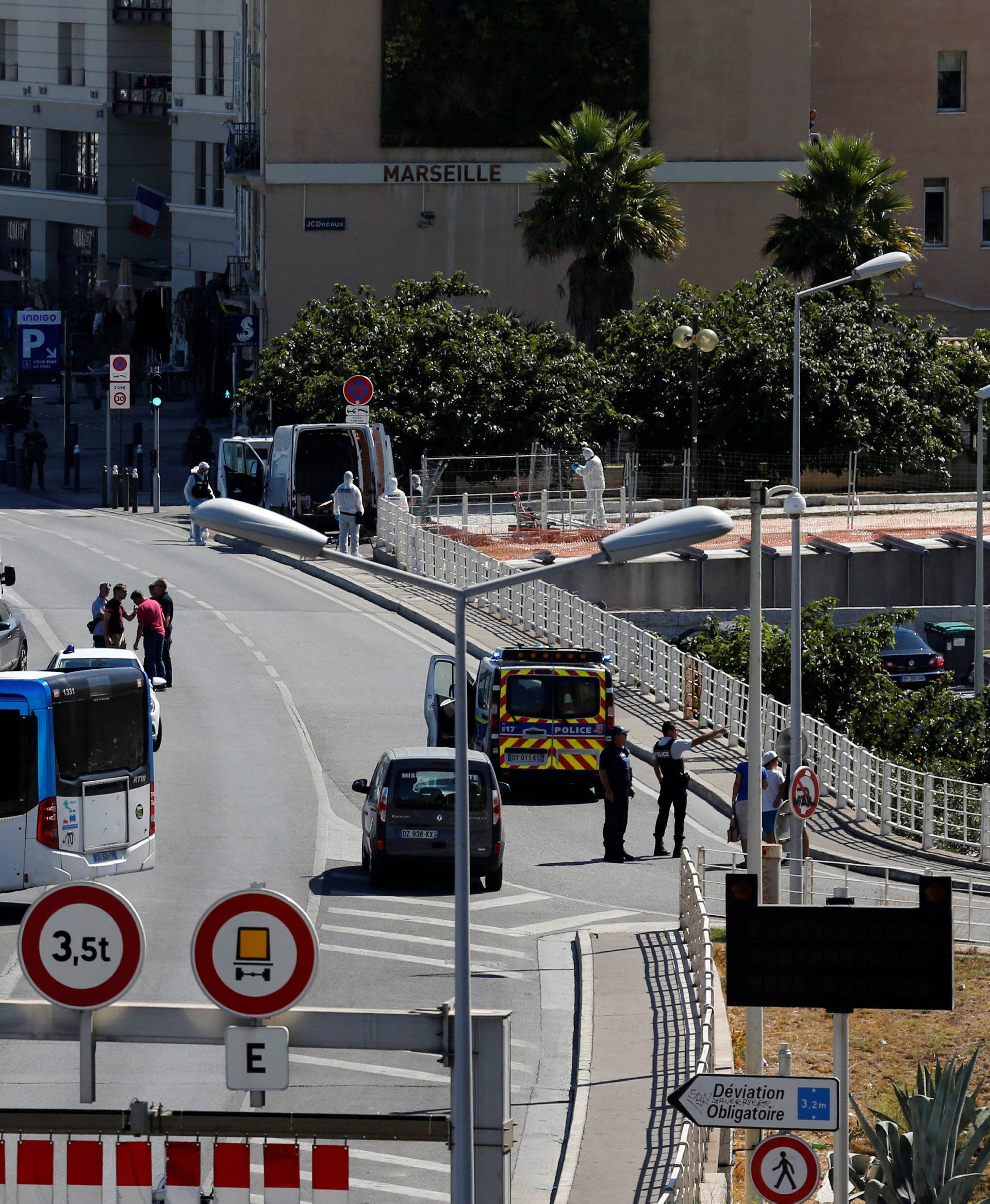 French police secure the area in the French port city of Marseille after one person was killed and another injured after a car crashed into two bus shelters