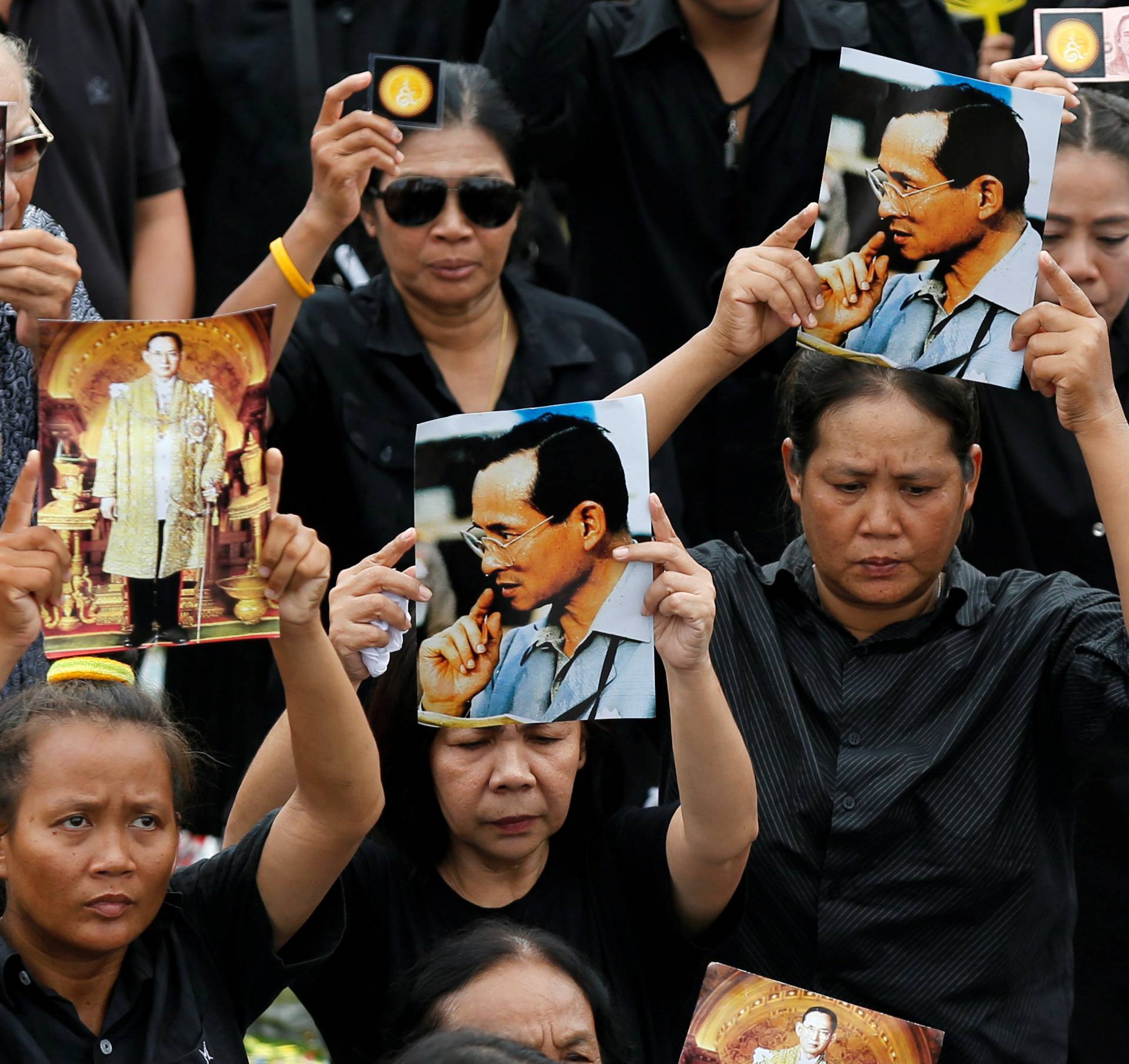 Mourners gather outside of the Grand Palace to sing for a recording of the royal anthem in honour of Thailand's late King Bhumibol Adulyadej, in Bangkok