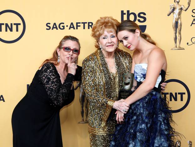 FILE PHOTO: Actress Debbie Reynolds poses backstage with her Lifetime Achievement award with her granddaughter Billie Catherine and daughter actress Carrie Fisher at the 21st annual Screen Actors Guild Awards in Los Angeles