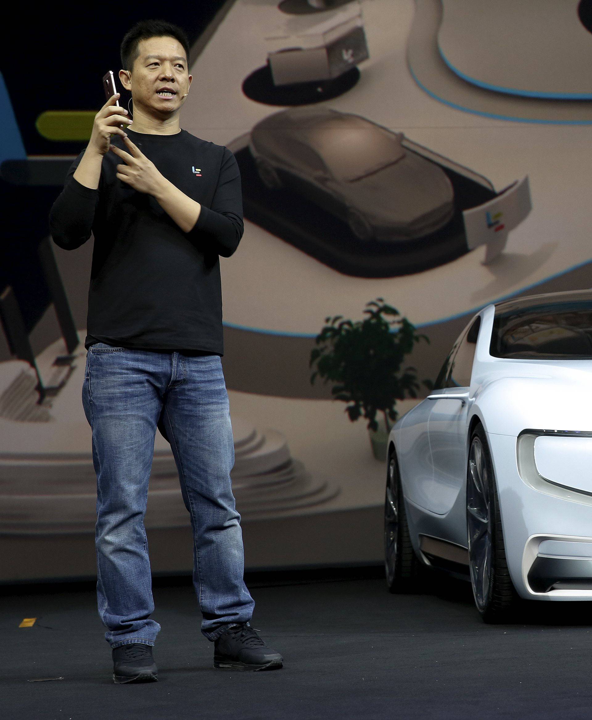 Jia, co-founder and head of Le Holdings Co Ltd, also known as LeEco and formerly as LeTV, gestures as he unveils an all-electric battery "concept" car called LeSEE during a ceremony in Beijingx