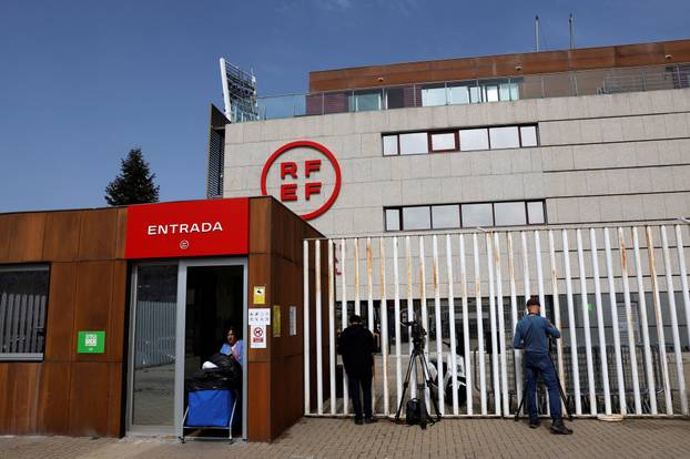 Media work outside the Spanish soccer federation headquarters as a search goes underway for evidence in a corruption probe, in Las Rozas