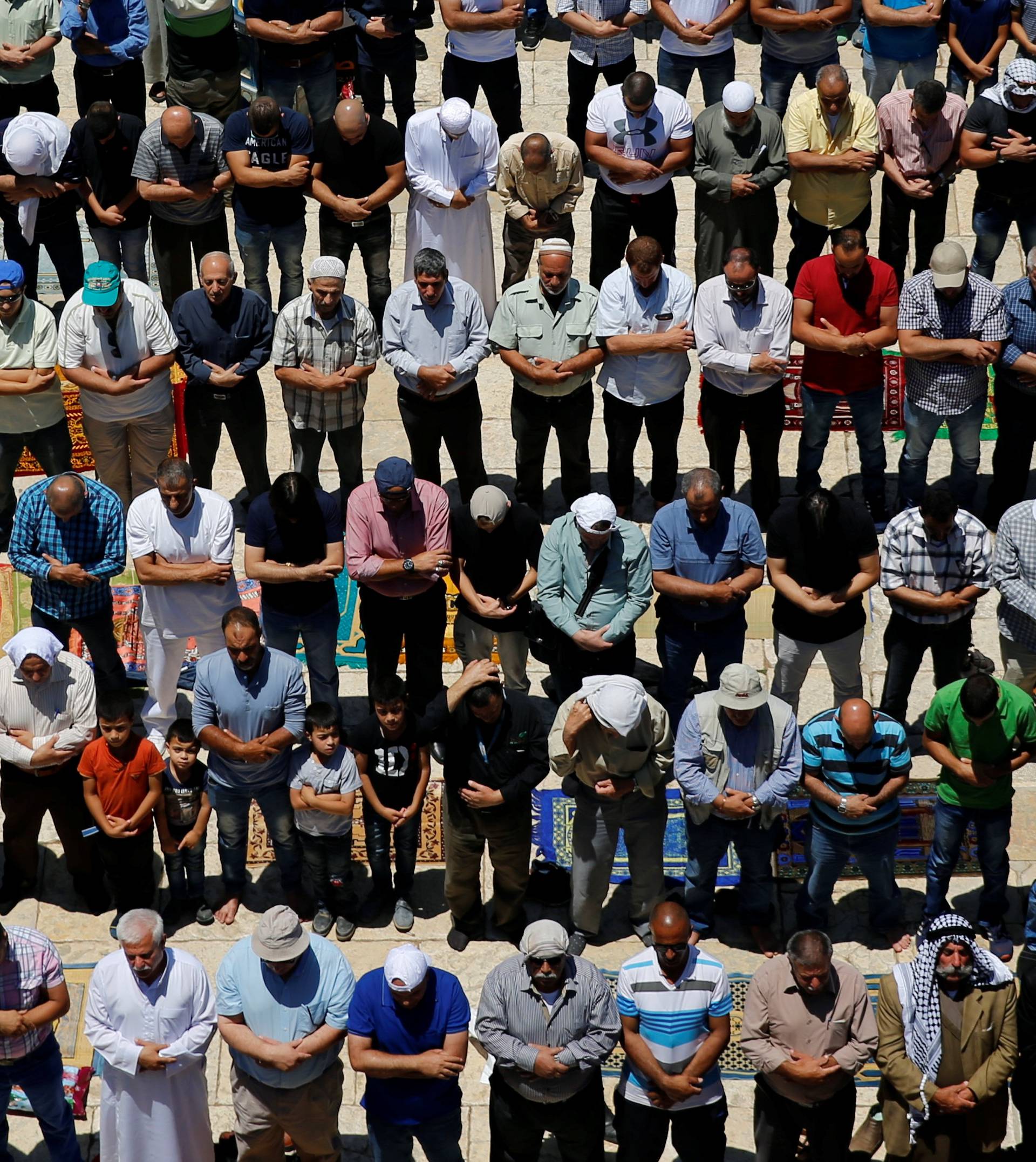 Palestinian men prays on the first Friday of the holy fasting month of Ramadan on the compound known to Muslims as Noble Sanctuary and to Jews as Temple Mount in Jerusalem's Old City