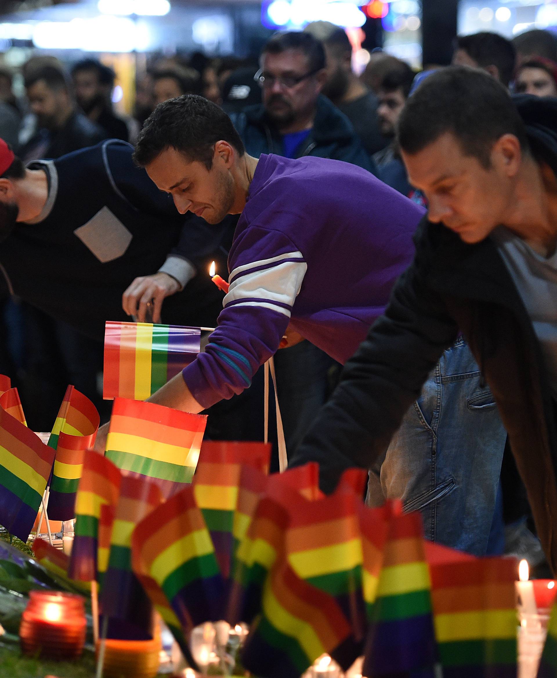 People gather at a vigil in solidarity for the victims of the Orlando nightclub mass shooting, at Taylor Square in Sydney