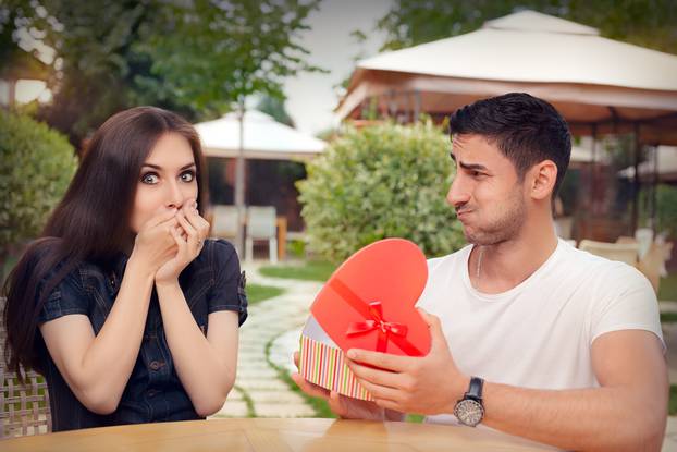 Happy Girl Receiving Heart Shaped Gift from her Boyfriend