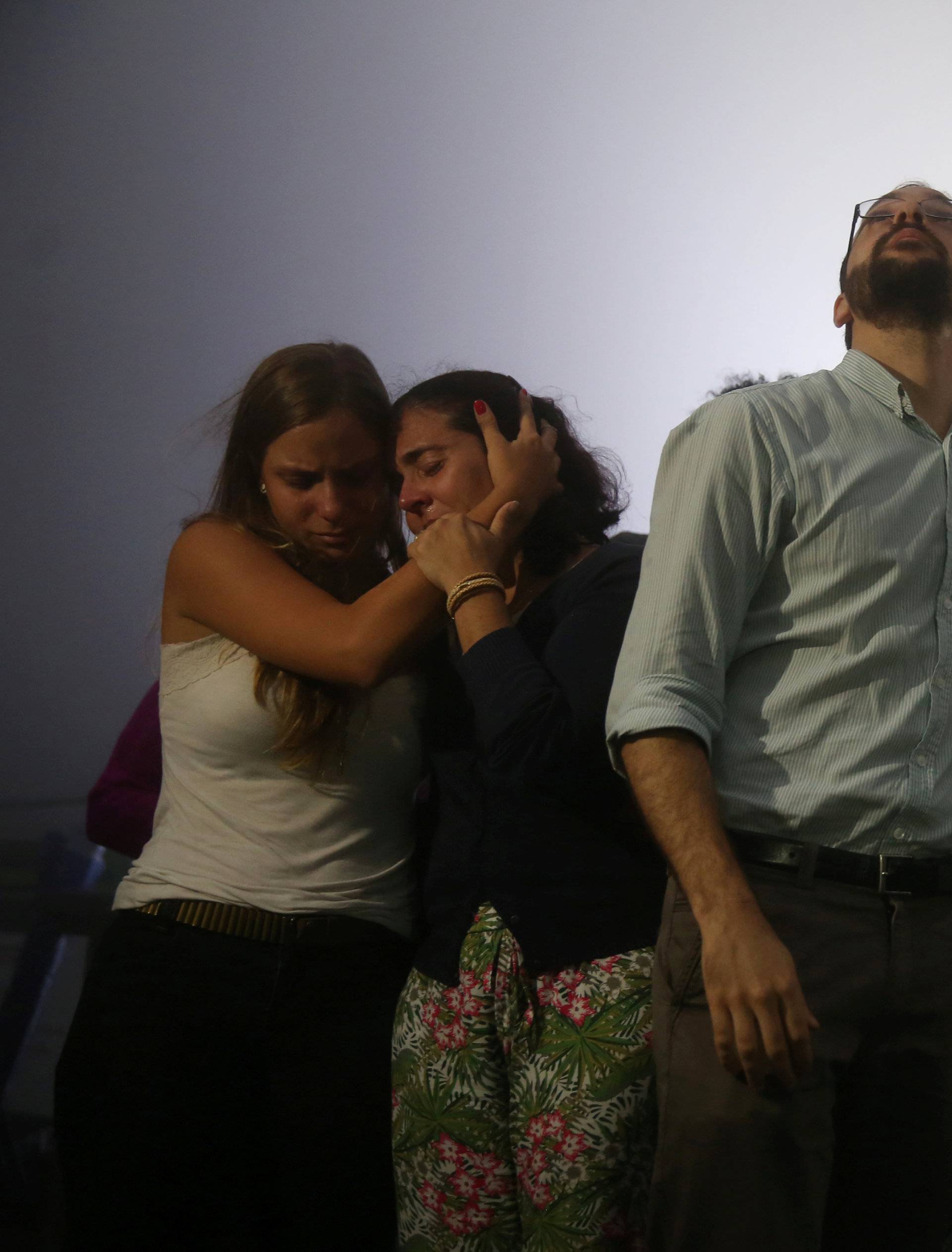 Relatives of Brazilian journalist Guilherme Marques mourn during a mass in Rio de Janeiro