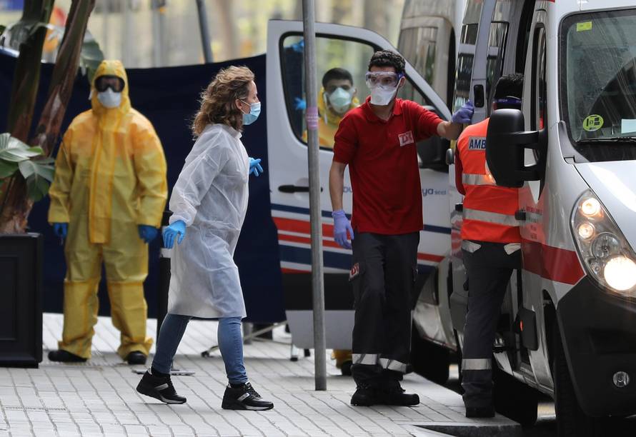 Medical workers are seen outside the Cotton House Hotel in Barcelona