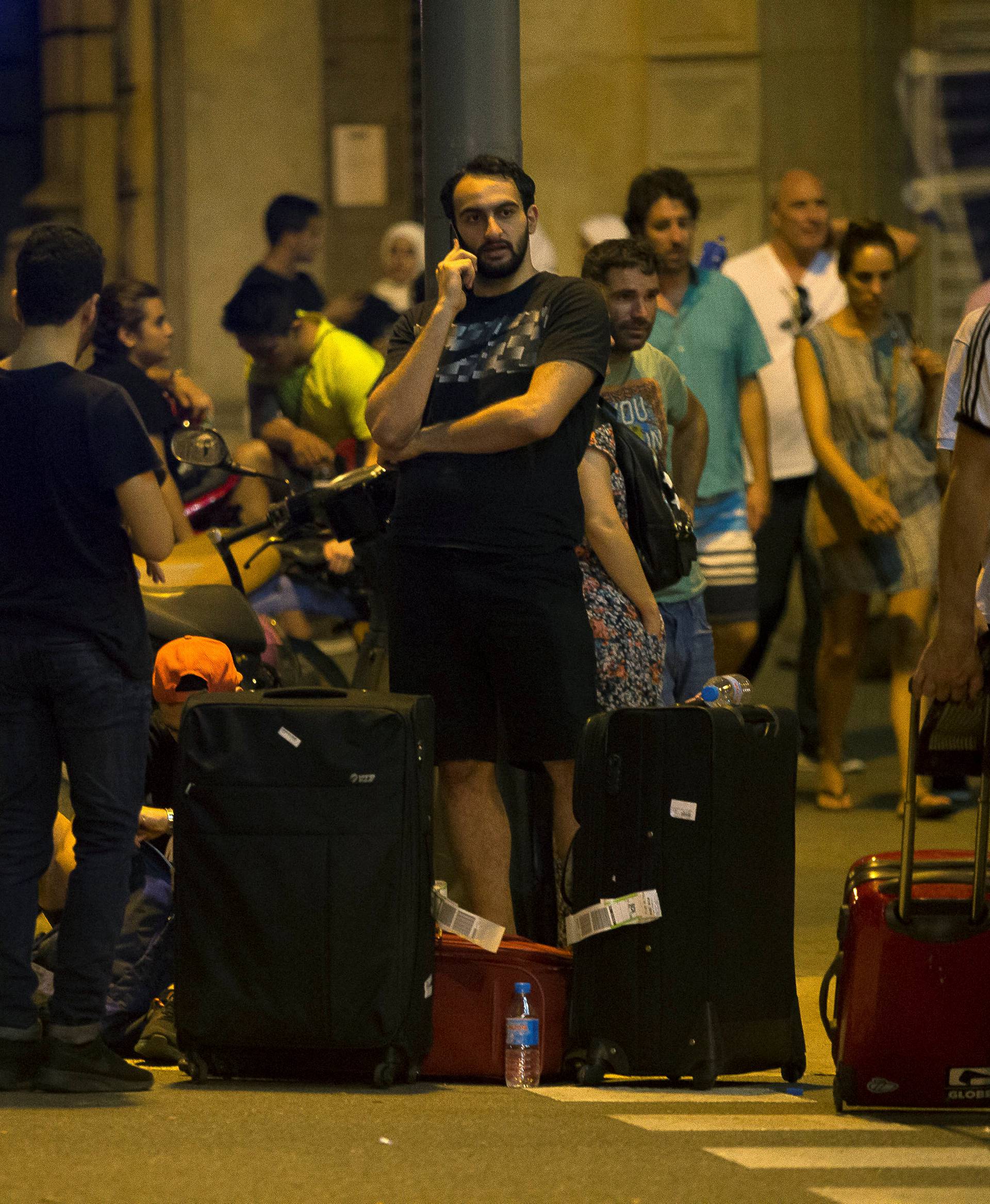 People wait to enter the area after a van crashed into pedestrians near the Las Ramblas avenue in central Barcelona