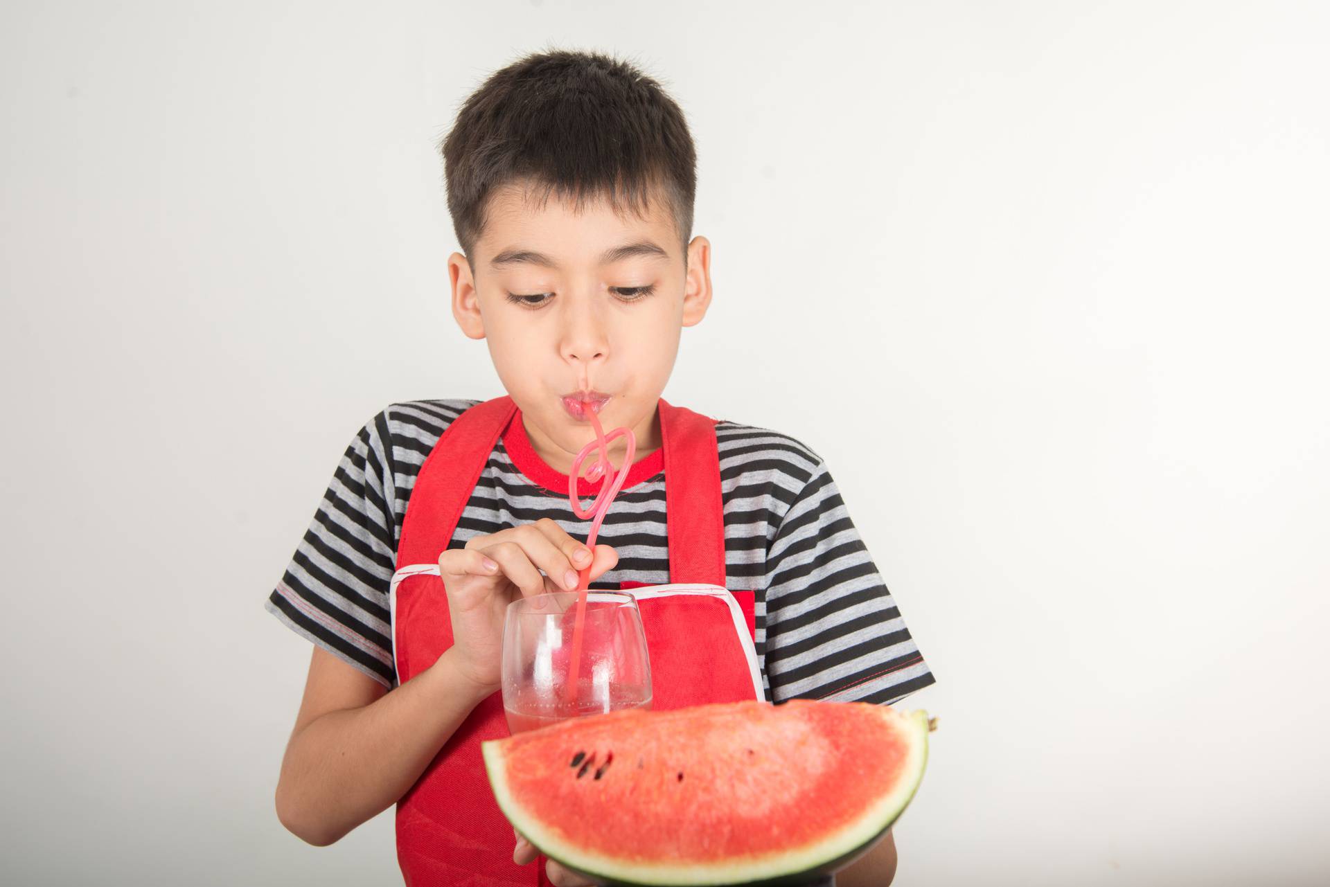 Little boys blend water melone juice by using blender at home