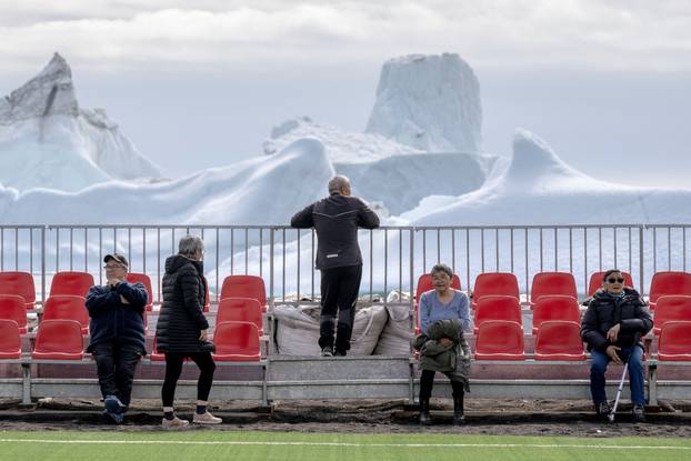 FILE PHOTO: Residents gather at a sports field in Qeqertarsuaq