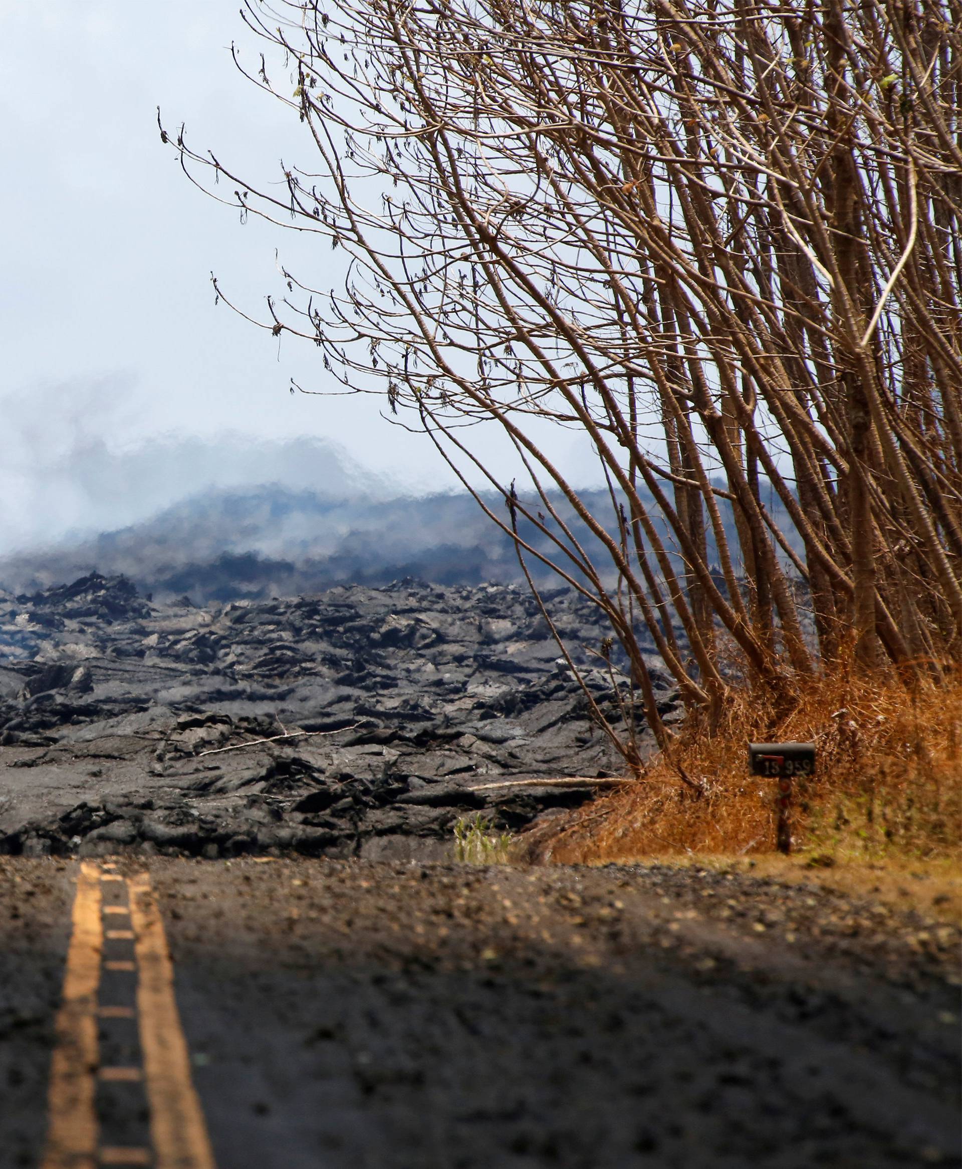 Soldiers from the Hawaii National Guard monitor sulfur dioxide gas levels near a lava flow in Leilani Estates during ongoing eruptions of the Kilauea Volcano in Hawaii