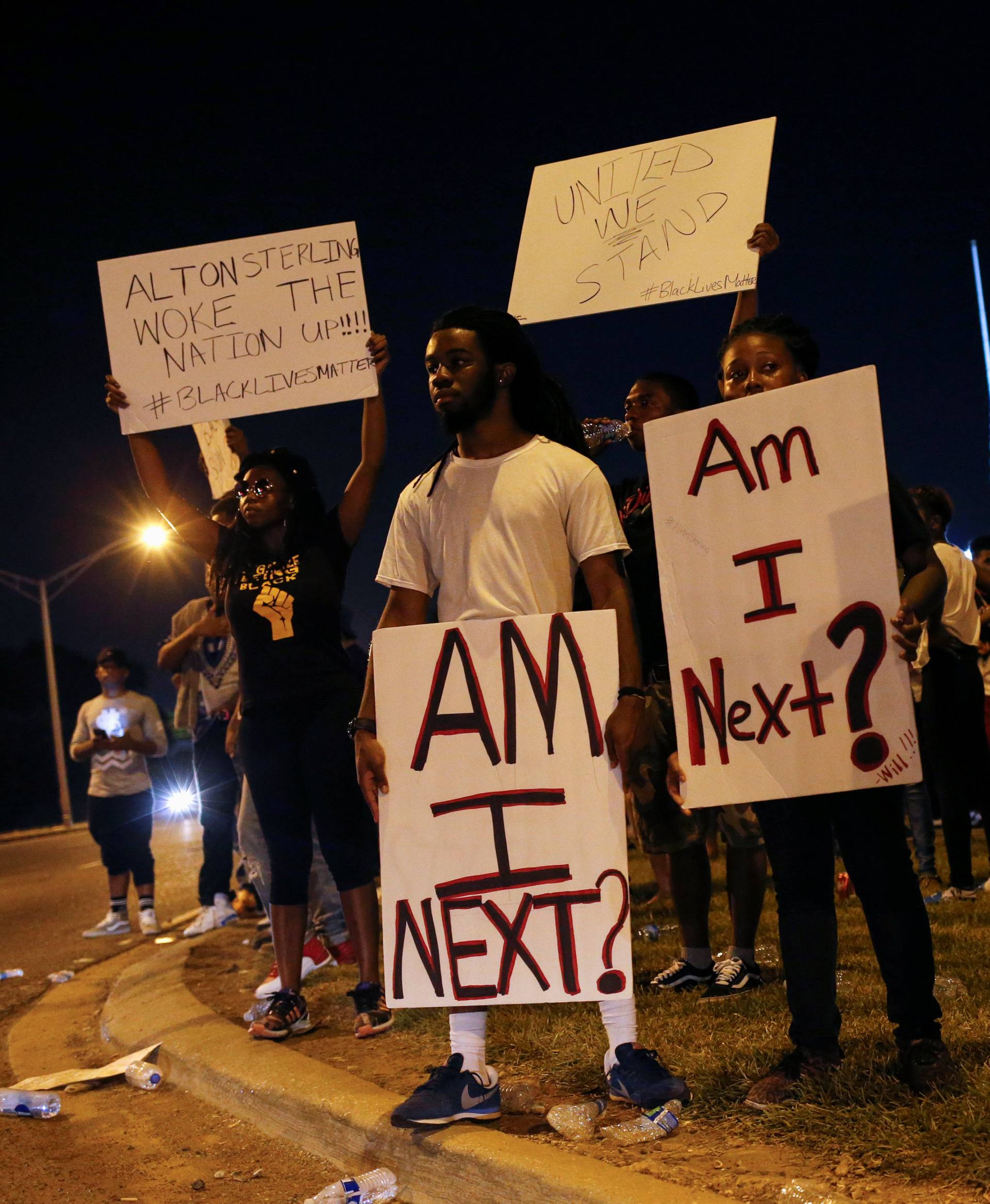 Demonstrators protest the shooting death of Alton Sterling near the headquarters of the Baton Rouge Police Department in Baton Rouge, Louisiana
