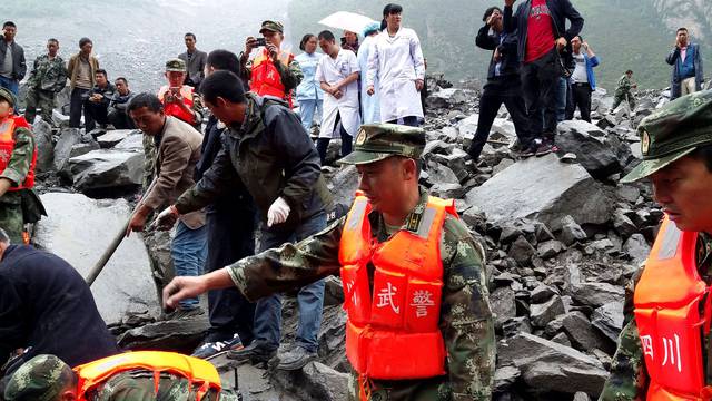 People search for survivors at landslide site that occurred in Xinmo Village