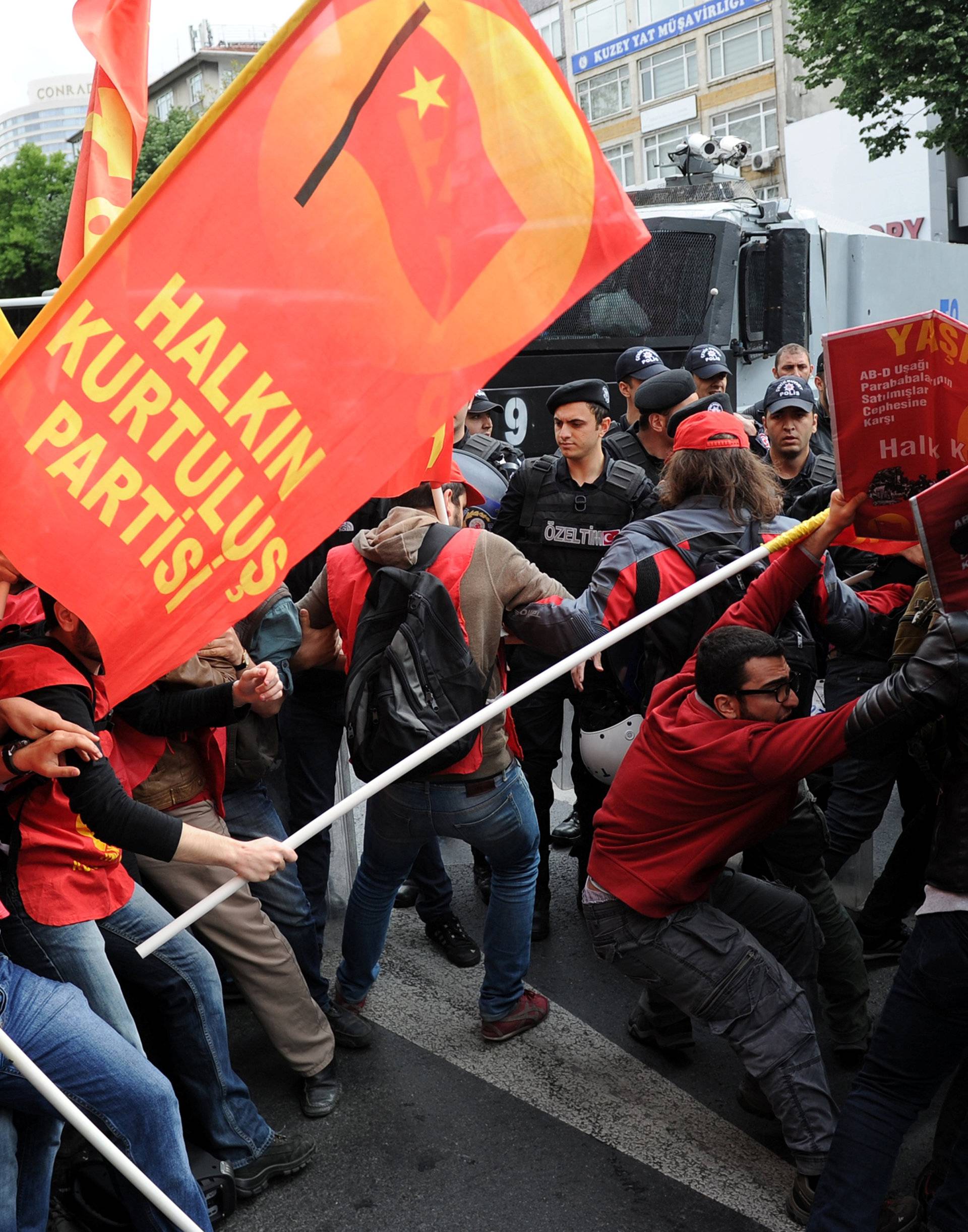 Turkish riot police scuffle with a group of protesters as they attempted to defy a ban and march on Taksim Square