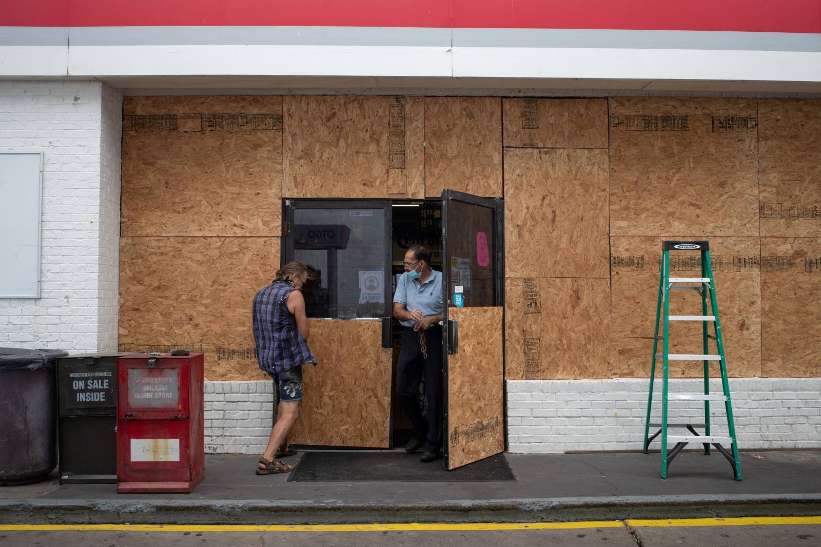 Man boards up convenient store ahead of Hurricane Laura in Galveston, Texas