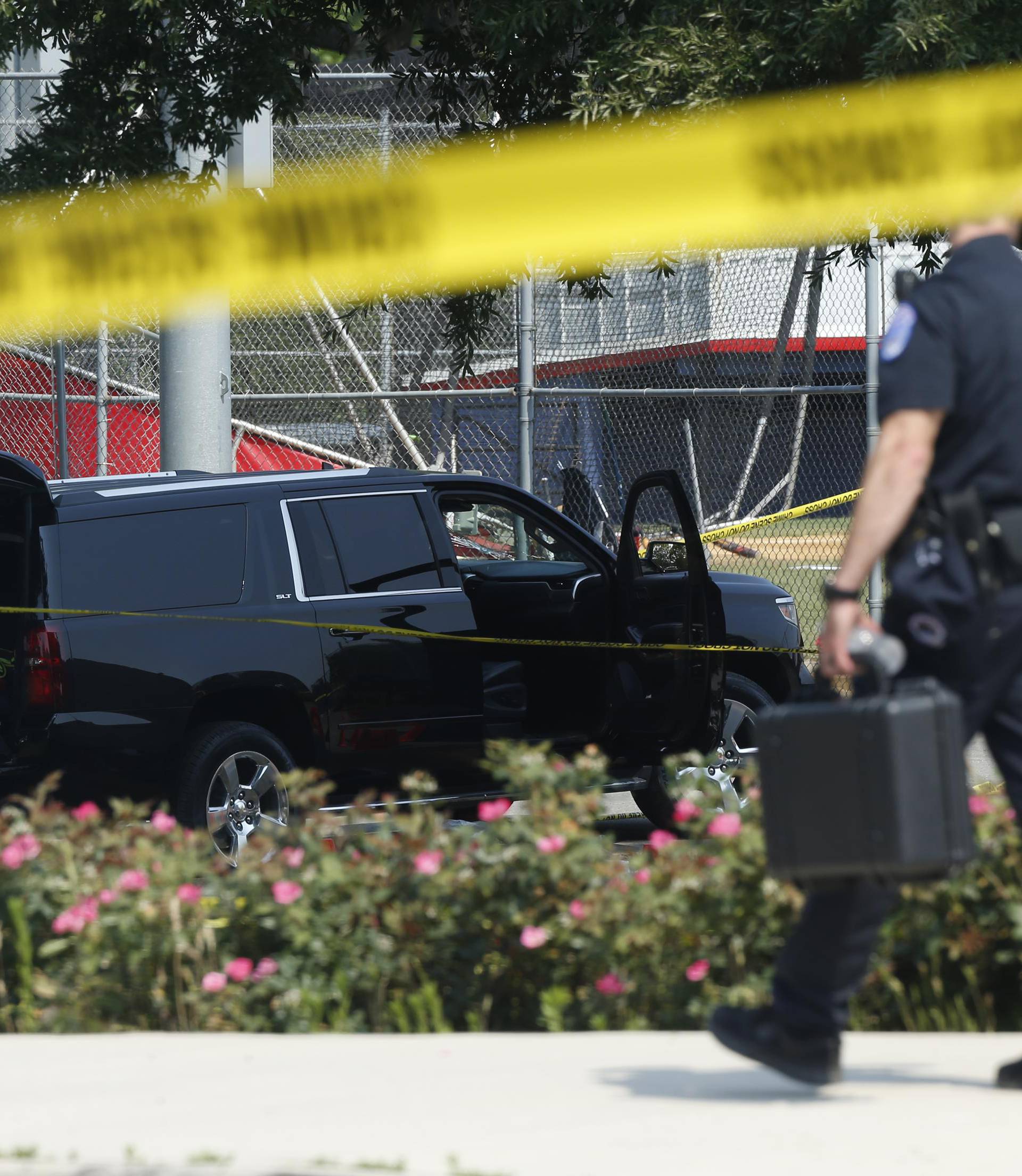 Police investigate shooting scene after a gunman opened fire on Republican members of Congress during a baseball practice near Washington in Alexandria, Virginia