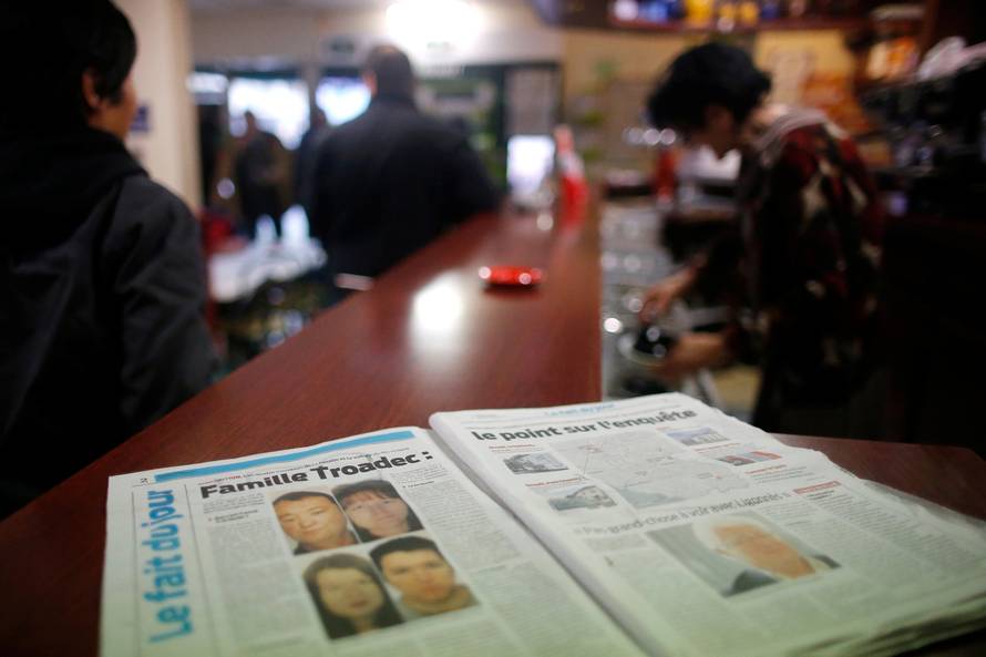 A newspaper sits on the counter of a neighborhood bar near the house of the Troadec family in Orvault