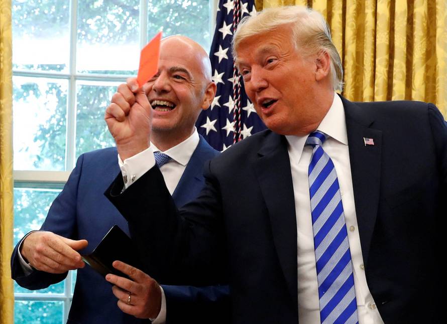 FILE PHOTO: U.S. President Donald Trump holds red card as he meets with FIFA President Infantino in the Oval Office of the White House in Washington