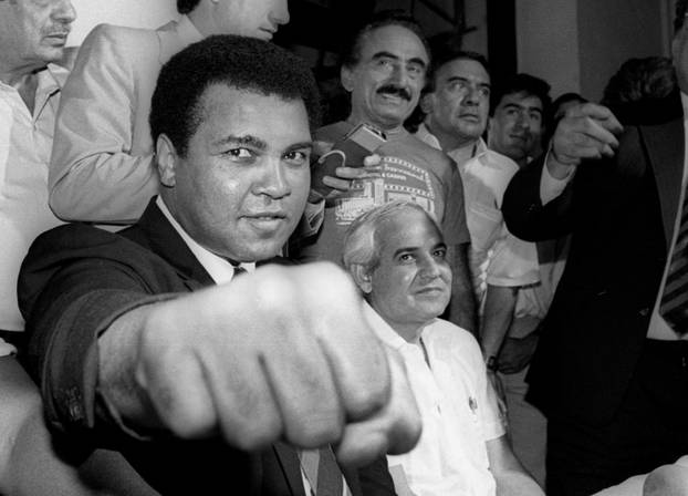 File photo of Muhammad Ali showing his fist to reporters during an impromptu news conference in Mexico City