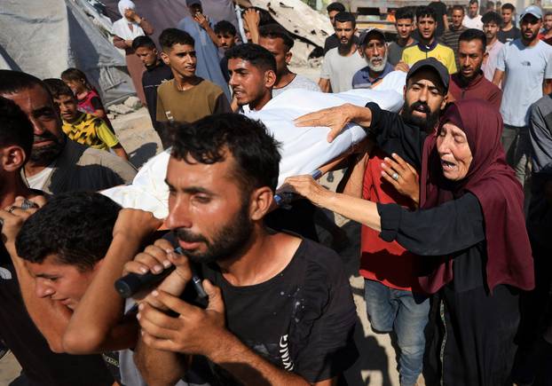 Mourners attend the funeral of Palestinians killed in overnight Israeli airstrikes, in Gaza City