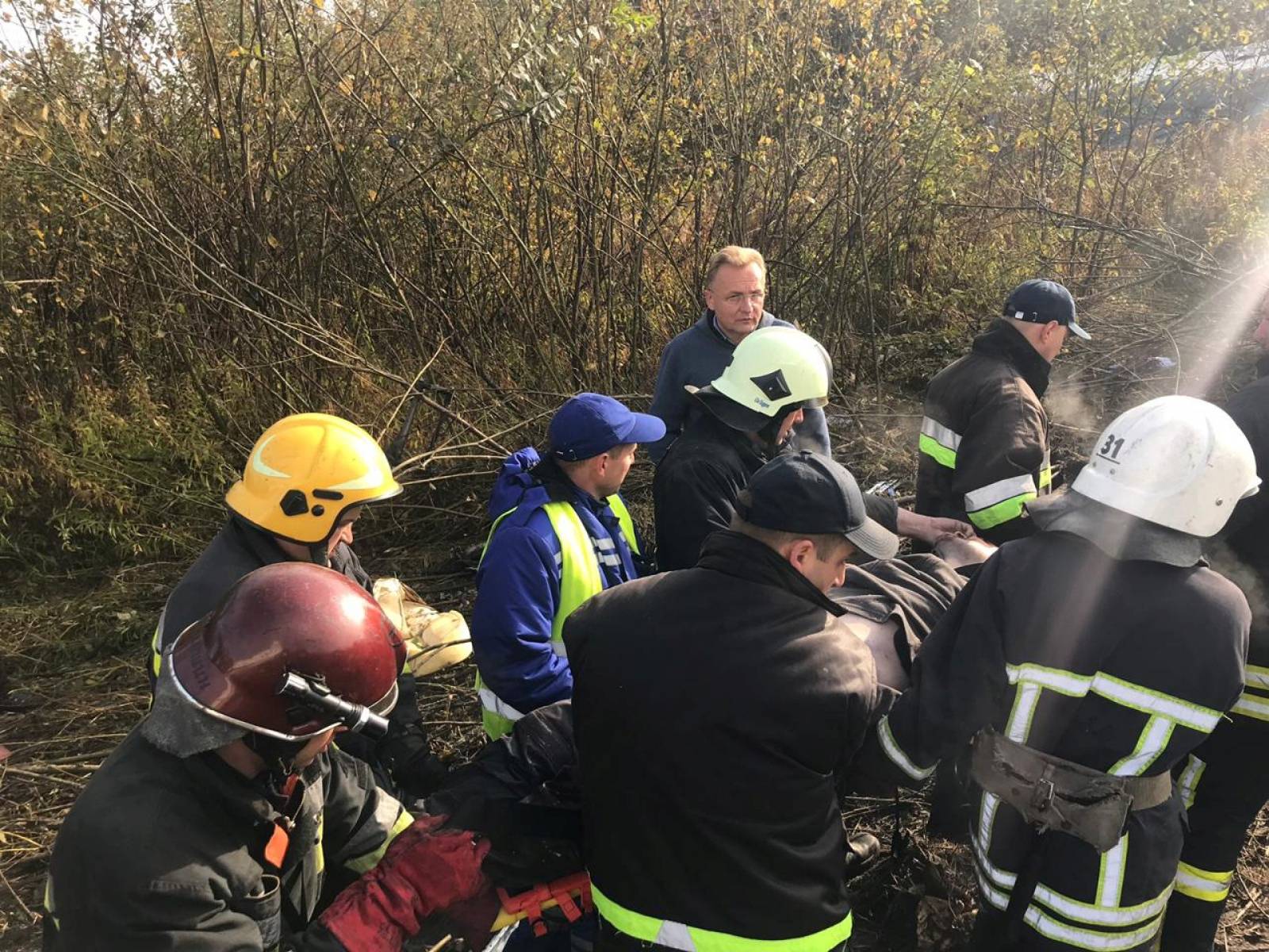 Members of emergency services evacuate a wounded person at the site of the Antonov-12 cargo airplane emergency landing in Lviv region
