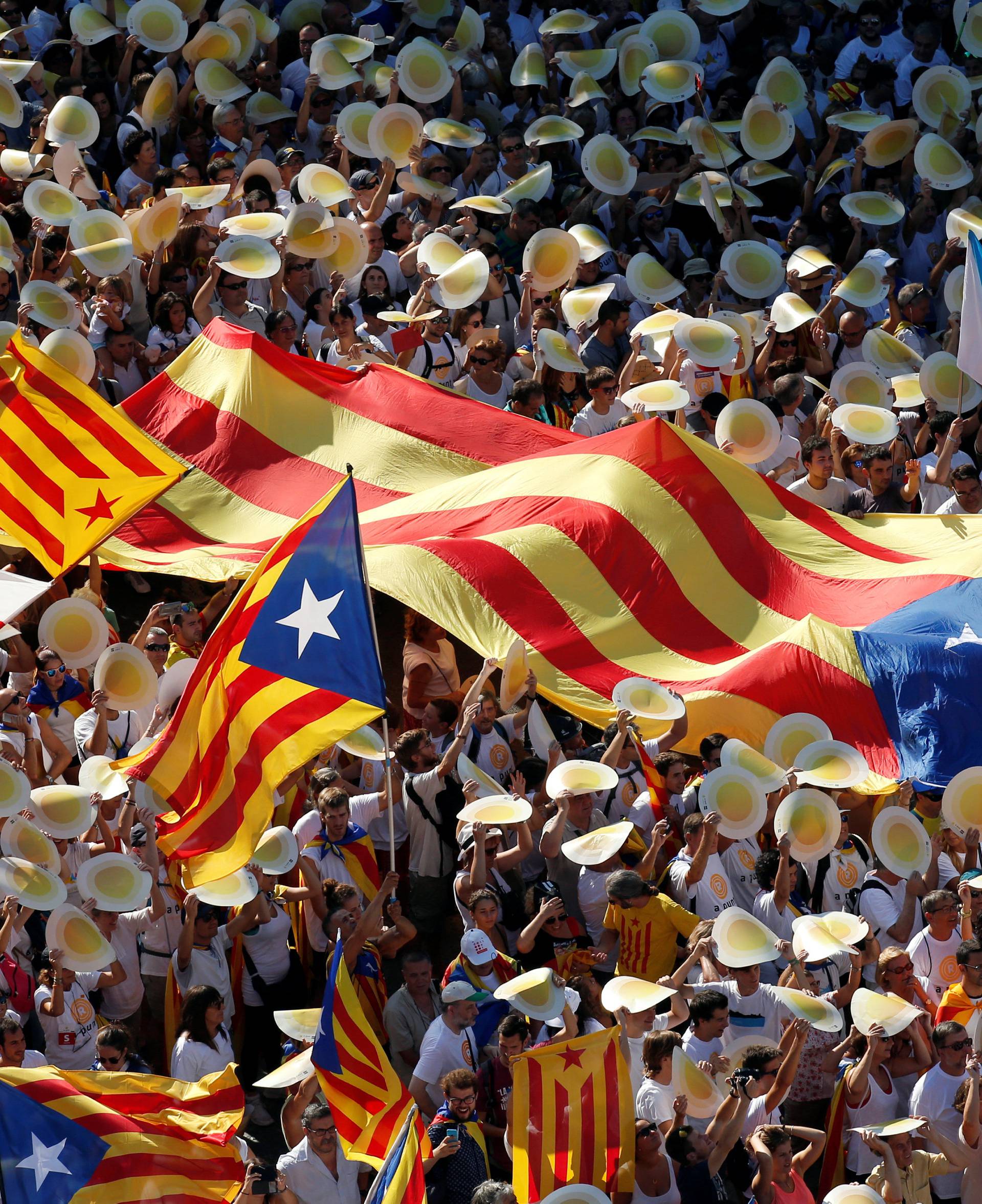 People hold Catalan separatist flags known as "Esteladas" during a gathering to mark the Catalonia day "Diada" in central Barcelona, Spain