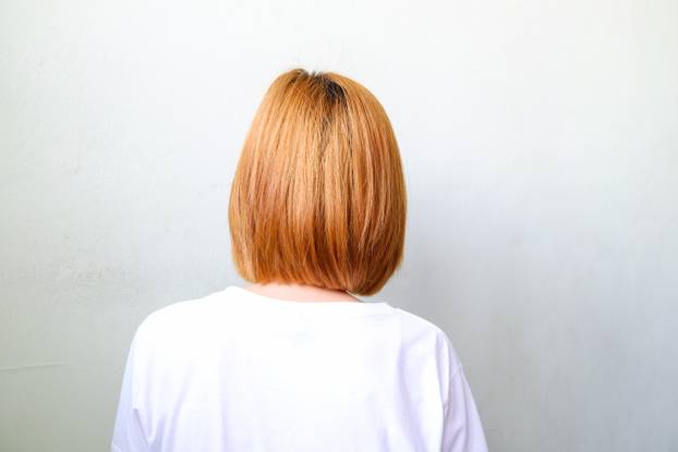 Behind of blond short hair woman