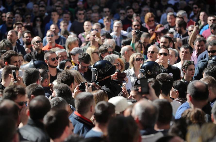 Demonstrators attend a protest against Serbian President Aleksandar Vucic and his government in front of the Presidential building in Belgrade