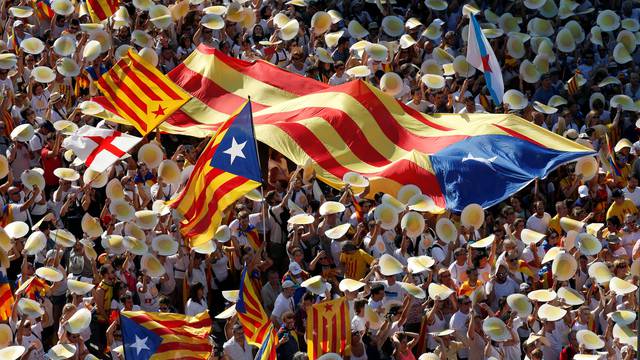 People hold Catalan separatist flags known as "Esteladas" during a gathering to mark the Catalonia day "Diada" in central Barcelona, Spain