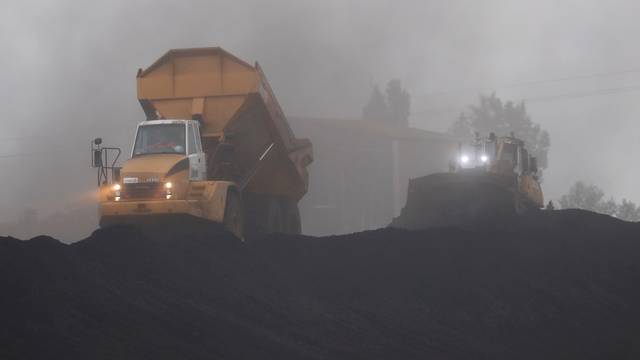 FILE PHOTO: An excavator operates at the coal terminal in Montoir-de-Bretagne near Saint-Nazaire