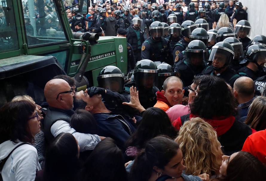Scuffles break out as officers force their way through crowd and into polling station for Catalonia referendum in Sant Julia de Ramis