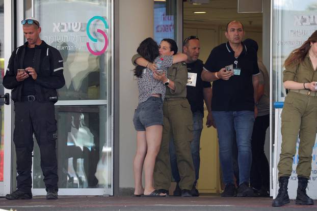 Families of hostages walk towards a hospital to meet with released hostages, in Ramat Gan
