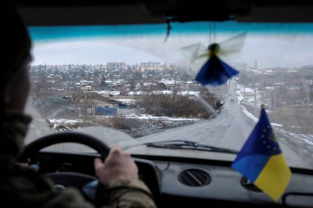 A Ukrainian serviceman drives a car in Bakhmut