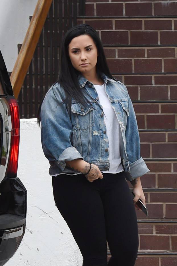 Demi Lovato is spotted heading to a office building after working out at the gym