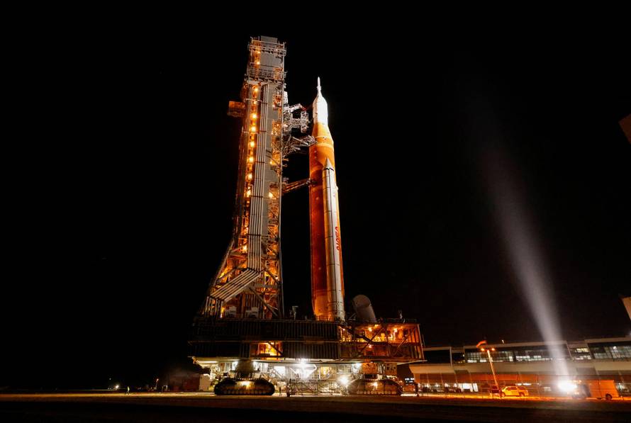NASA's next-generation moon rocket, the Space Launch System (SLS) rocket with the Orion crew capsule, rolls again to Pad 39B for launch