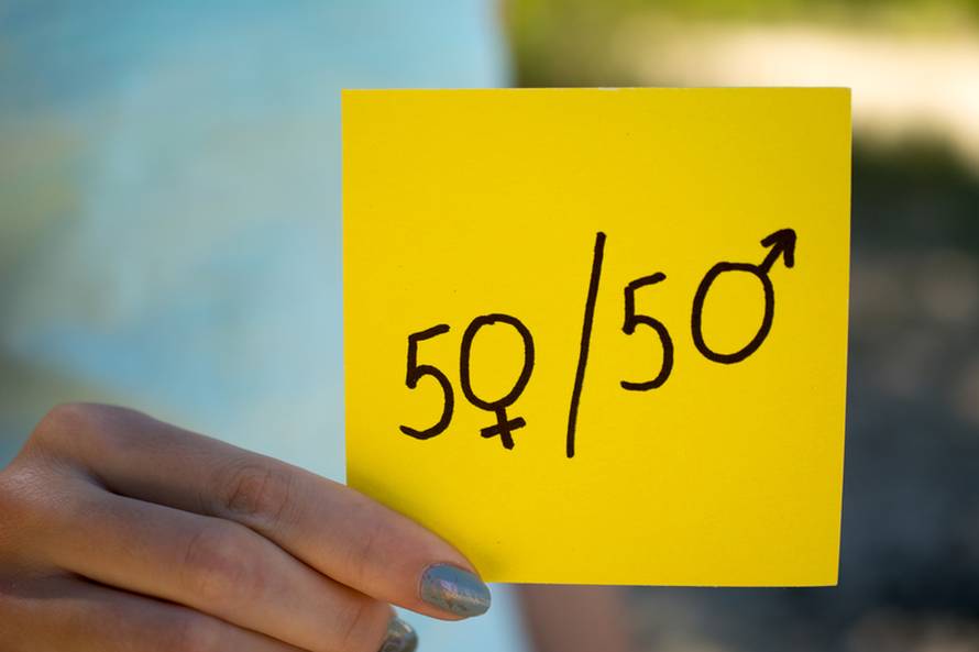 gender equality concept, a piece of paper with a female and a male symbol in a woman's hand