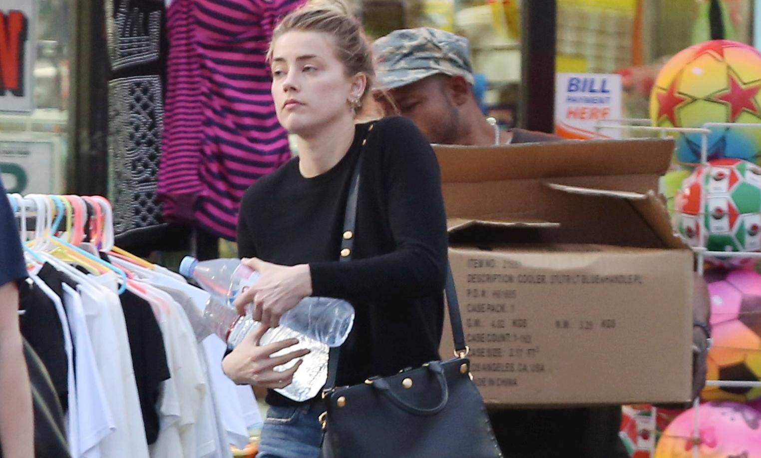 Amber Heard shops at a 99 Cent discount store and earlier seen chatting to a mystery male friend in Los Angeles