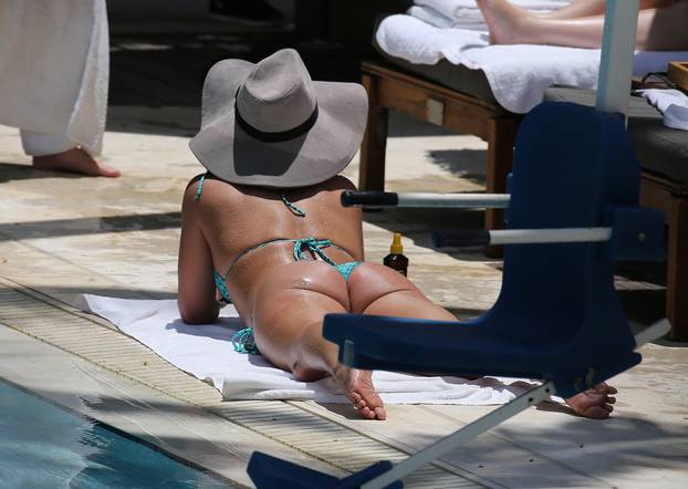 EXCLUSIVE: Britney Spears wears a very cheeky blue bikini as she sunbathes in Miami