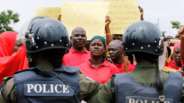 A parent of one of the abducted Chibok school girls cries after the police prevented the parents access to see President Muhammadu Buhari during a rally in Abuja, Nigeria