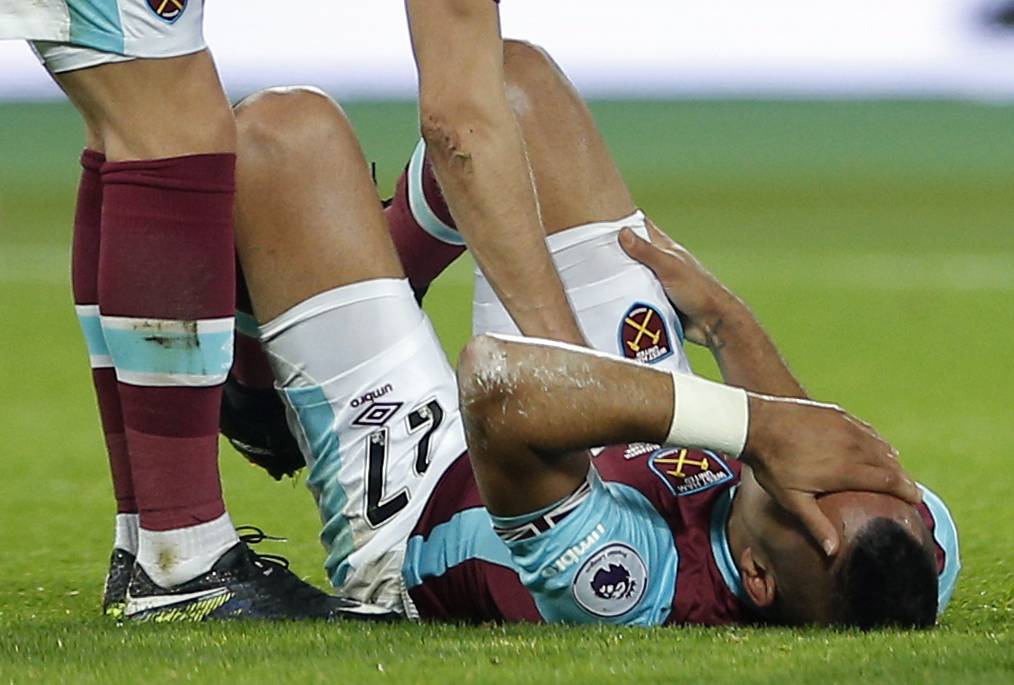 West Ham United's Dimitri Payet lies injured