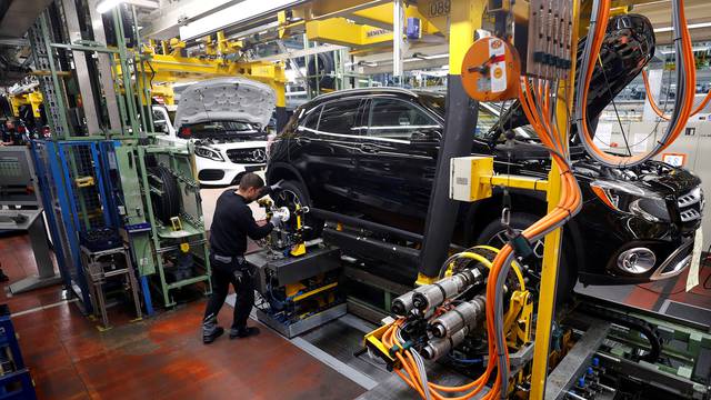 FILE PHOTO: An employee of German car manufacturer Mercedes Benz installs wheels at a A-class model at the production line at the Daimler factory in Rastatt