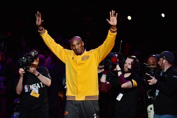 FILE PHOTO: Los Angeles Lakers forward Bryant waves to the crowd in Los Angeles
