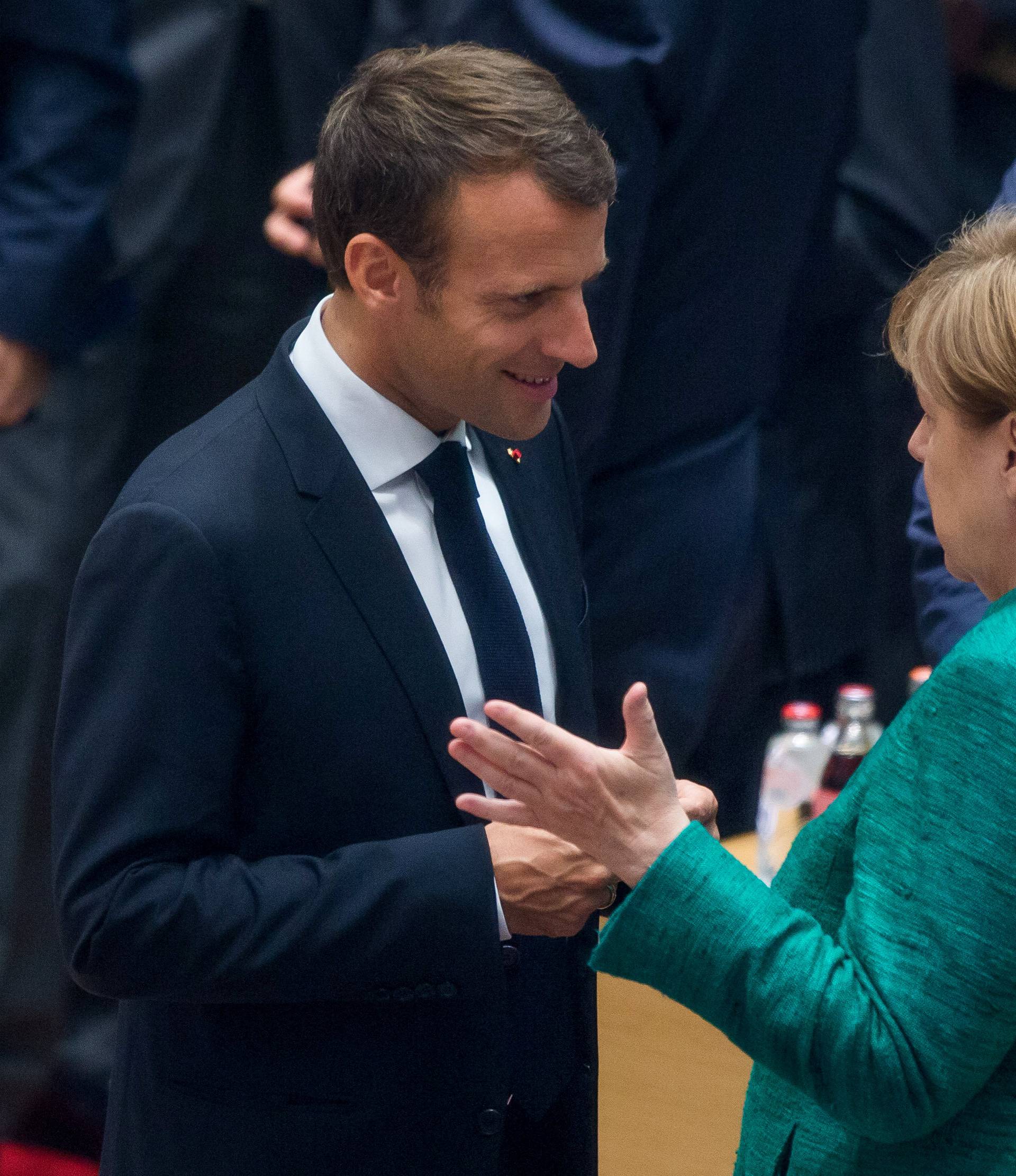 French President Emmanuel Macron and German Chancellor Angela Merkel take part in a European Union summit in Brussels