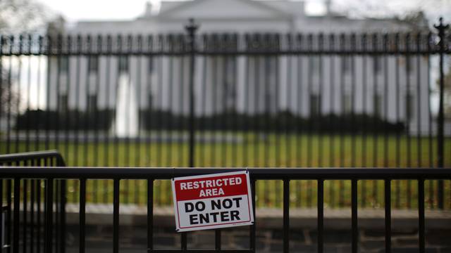FILE PHOTO: A restricted area sign is seen outside of the White House in Washington