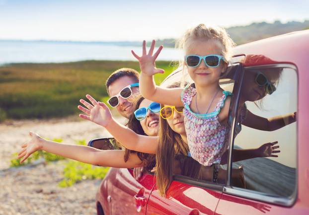 Portrait,Of,A,Smiling,Family,With,Two,Children,At,Beach